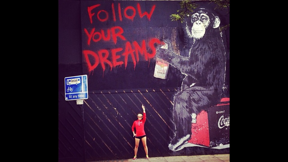 Picture of Robin Arzon with Wall that says Follow Your Dreams