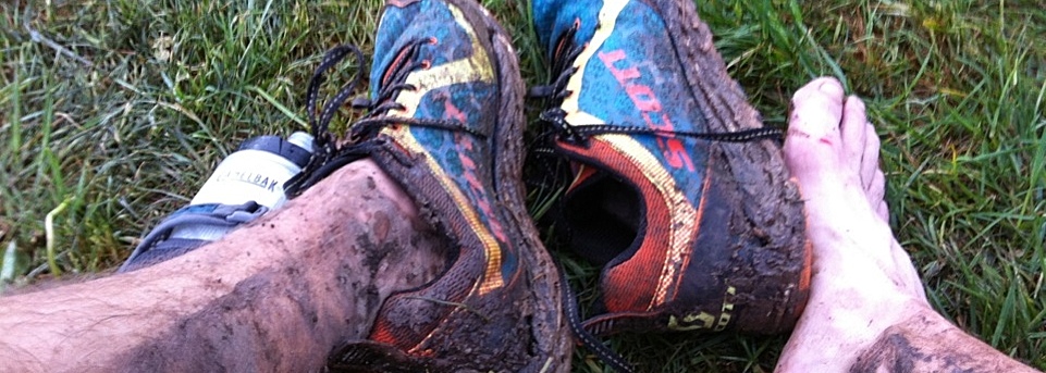 picture of muddy legs and scott shoes after a wet trail run